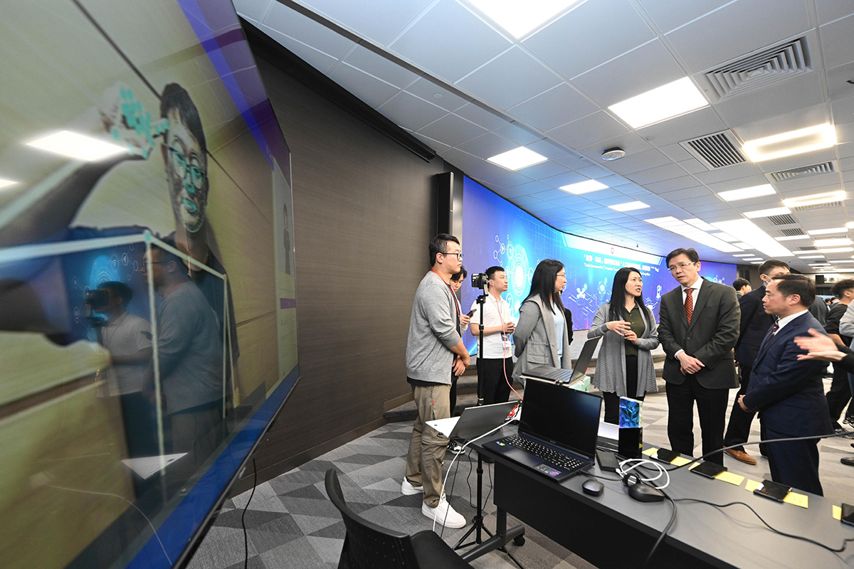 The Secretary for Innovation, Technology and Industry, Professor Sun Dong (second right), is briefed on the grand award project “Improving communications through generative sign language” at the Award Presentation Ceremony for the “Innovative Application with AI” Innovation Competition today (March 15). Looking on is the Government Chief Information Officer, Mr Tony Wong (first right).