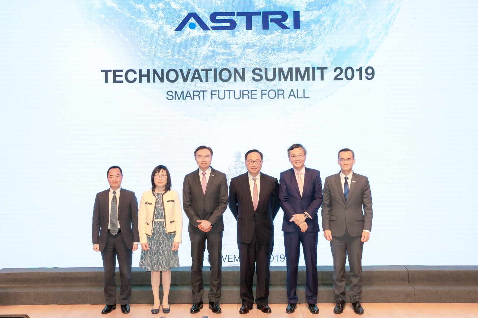 Mr. Tony Wong, Assistant Government Chief Information Officer (Industry Development) (left) in group photo with Mr. Nicholas W Yang, Secretary for Innovation and Technology Bureau (third right), Ms. Rebecca Pun, Commissioner for Innovation and Technology (second left), Mr. Sunny Lee, Chairman, Hong Kong Applied Science and Technology Research Institute (third left), Dr. Lam Ching-choi, Chief Executive Officer, Haven of Hope Christian Service (second right), and Mr. Hugh Chow, Chief Executive Officer, Hong Kong Applied Science and Technology Research Institute (first right) at the “Technovation Summit 2019”.