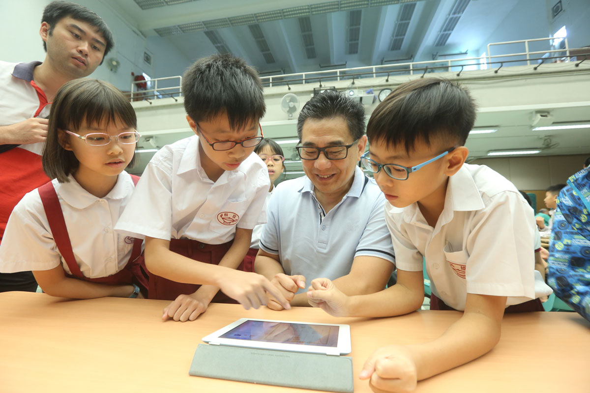 Ir. Allen Yeung, JP, Government Chief Information Officer (GCIO), trying the AI Chinese Chess Program with students – photo 16