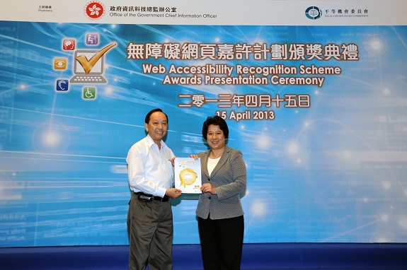 The Permanent Secretary for Commerce and Economic Development (Communications and Technology), Miss Susie Ho, JP (right), presents a Gold Award certificate to the Senior Manager of Fish Marketing Organization, Mr Wong Pui-kwong