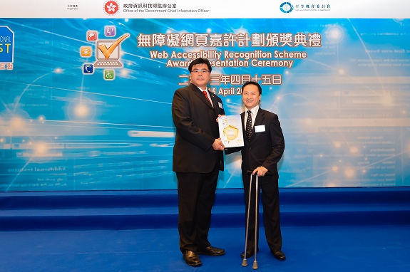 Equal Opportunities Commission member, Mr Nelson Yip, MH (right), presents a Gold Award certificate to the Development Manager of NewTrek Systems Limited, Mr Johnny Yau