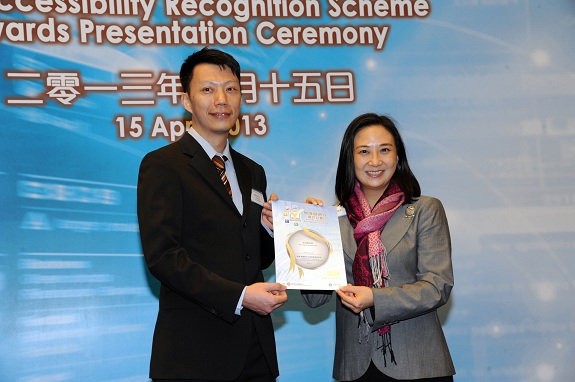 Legislative Council member, Dr Hon Elizabeth Quat, JP (right), presents a Silver Award certificate to the Design and Development Manager of The Hong Kong Jockey Club, Mr Biondi Tang